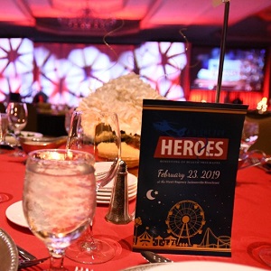 Night for Heroes table with drink and invite