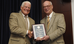 Image: William Livingood Jr., PhD, left, receives this year’s Robert C. Nuss Researcher/Scholar Award from Daniel Wilson, MD, PhD, dean of the UF College of Medicine – Jacksonville.