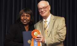 Image: Alexandra Joseph, MD, receives the first-place award for platform presentations from Daniel Wilson, MD, PhD, dean of the UF College of Medicine – Jacksonville.