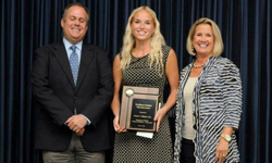 Image: Emergency medicine resident Brandi Gilchrist, MD (center), receives the UF College of Medicine Excellence in Student Education Resident Award from Genuardi and Edwards.