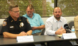 Image: Matthew Hale, MD, at right, an assistant professor of emergency medicine at University of Florida College of Medicine – Jacksonville, speaks about the harms of synthetic marijuana during an Aug. 14 meeting as law officers and news reporters listen.