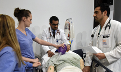 Image: Residents Yarelies Malave-Diaz, MD (emergency medicine), and Amit Babbar, MD (internal medicine), and cardiovascular disease fellow Wassim Jawad, MD, tend to a manikin patient during the Sim Wars competition.