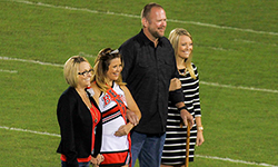 Image: Mark kept his promise to his daughter Masey to walk her across the football field during her high school