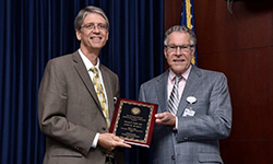 Image: Steven Cuffe, MD, left, professor and chair of psychiatry at the University of Florida College of Medicine – Jacksonville, receives the Robert C. Nuss Researcher/Scholar Award from George Wilson III, MD, senior associate dean for clinical affairs at UFCOMJ.