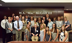Image: Family members gather around William A. “Mac” McGriff III for a photo following a special ceremony to rename the Shands Boardroom in his honor.