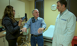 Image: UF Health Jacksonville neurologist Odinachi Oguh, MD, left, and neurosurgeon Daryoush Tavanaiepour, MD, treated John