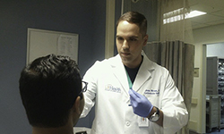 Image: Jose Rivas, MD, a postdoctoral research associate at the University of Florida College of Medicine – Jacksonville, performs a genetic swab on a cardiovascular patient.