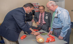 Image: Wayne Marshall, vice president of UF Health North, shows UF Health Jacksonville CEO Russ Armistead how to control bleeding with gauze.