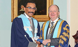 Image: Michael Lavelle-Jones, right, president of the Royal College of Surgeons of Edinburgh, congratulates Rui Fernandes, MD, DMD, on his induction into the organization as an ad hominem fellow.