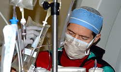 Image: Schwan adjusts a fluid bag during the procedure, which was to correct an abnormal heart rhythm.