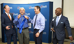 Image: UF Health leaders celebrate during a ceremonial ribbon-cutting to mark the opening of the Jacksonville Aging Studies Center. Pictured, from left, are UF Health President David S. Guzick, MD, PhD; Marco Pahor, MD, director of the UF Institute on Aging; Steve Anton, PhD, chief of clinical research in the department of aging and geriatric research; and Leon L. Haley Jr., MD, MHSA, dean of UF COMJ and CEO of UF Health Jacksonville.