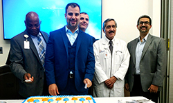 Image: Kourosh Tavanaiepour, DO, an assistant professor of neurosurgery at UF COMJ, stands in front of the celebratory cake as other spine center neurosurgeons join him for a photo op. Tavanaiepour directs the center.