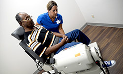 Image: A JAX-ASCENT staff member guides a patient volunteer through his physical assessment. People 60 and older are encouraged to join the center