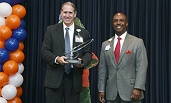 Image: David Caro, MD, a professor of emergency medicine and director of the emergency medicine residency program, is the winner of this year’s Meritorious Award for Outstanding Service. He was joined onstage by Leon L. Haley Jr., MD, MHSA, dean of the UF College of Medicine – Jacksonville.