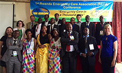 Image: In this photo from 2016, DeVos, on the far left in black, gathers with a group of Rwandan emergency medicine resident physicians during the first Rwanda Emergency Care Association Conference.