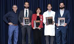 Image: Four of the award winners display their plaques during Wednesday’s festivities. They are, from left, Aaron Richardson, MD, MS; Elisa Sottile, MD; Anthony Stack II, DO; and Barrett Attarha, DO.