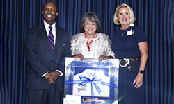 Image: Cheryl Iglesia, MD, displays her Distinguished Alumni Award.