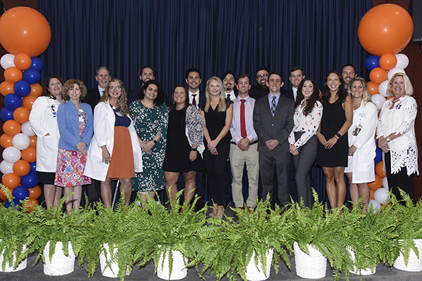 Image: Graduates of the emergency medicine residency program gather for a group photo as they celebrate academic achievements at this year’s Celebration of Resident and Fellow Education and Research Day.