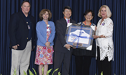 Image: Thomas T. Chiu, MD, MBA, displays his Distinguished Alumni Award.