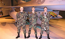 Image: Smith stands with fellow members of the Air Force in front of an aircraft.