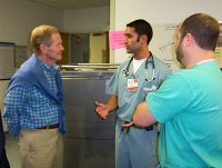 Image: U.S. Sen. Bill Nelson, D-Fla., and UF College of Medicine–Jacksonville emergency medicine residents discuss the legislation Nelson and U.S. Sen. Harry Reid, D-Nev., introduced in February to increase the number of residency slots in 24 states, including Florida. Pictured (left to right) are Nelson, third-year emergency medicine resident Paul Chillar, M.D., and second-year emergency medicine resident Kerry Bachista, M.D. (Photo by Michelle Barth)