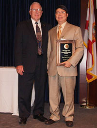 Image: Thomas Chiu, M.D. receives the Louis Russo Award from Robert Nuss, M.D.