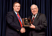 Image: 2011 Faculty Researcher/Scholar of the Year, Mark L. Hudak, M.D., left, receives his award from Robert C. Nuss, M.D.