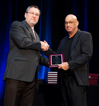 Image: Eric B. Stewart, M.D. (right) accepts an award from the Health Resources and Services Administration.