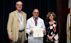 Image: Joseph Sabato Jr., M.D. (middle), a UF assistant professor of emergency medicine, is presented the Most Outstanding Poster Presentation by Faculty Award by Daniel Wilson, M.D., Ph.D., dean of the UF College of Medicine-Jacksonville, and Elisa Zenni, M.D., associate dean for educational affairs