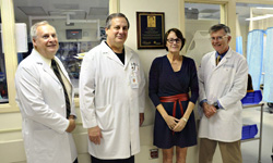 Image: Three of Dr. Eric Frykberg’s closest friend, Dr. James Dennis, Dr. David Vukich and Dr. Joseph Tepas stand with Frykberg’s wife, Patti Frykberg, next to the plaque.